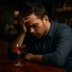 Alcohol Addiction person at bar looking hopeless