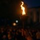 Charlie Kirk memorial torch held high in a crowd