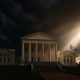Virginia State Capitol under storm clouds with sunlight breaking through, symbolizing truth and redemption in the Jay Jones scandal