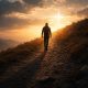 Man walking uphill at sunrise symbolizing the weight of obedience with same sex attraction