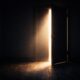 Partially open door with light shining into a dark room symbolizing struggling with sin and leaving the door open