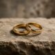 Two gold wedding rings resting on a stone surface, symbolizing God's design for marriage and biblical sexual ethics.